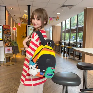 Vibrant multi-colored travel backpack for students shown in a casual lifestyle setting