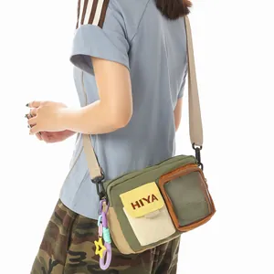 Casual outdoor sports crossbody bag in olive green featuring a unique transparent pocket detail