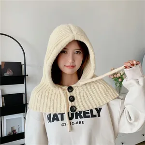Detailed view of warm cream knitted hooded scarf shawl with buttons and drawstring