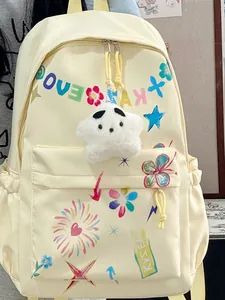 Fashionable cream backpack with colorful graffiti prints and a plush star charm