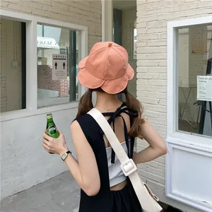 Back view of a coral lotus leaf bucket hat with pleated flower edge for sun protection