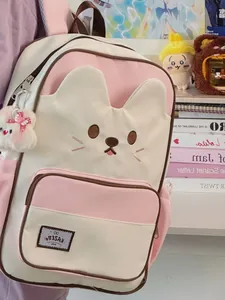 Cute cat-themed pink and white school backpack for girls featuring a fuzzy plush bunny charm