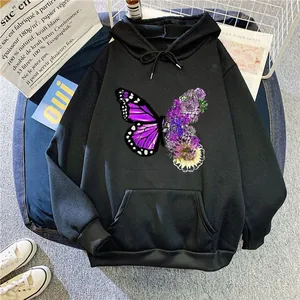 Detail view of the artistic purple butterfly and floral print on a black hooded sweatshirt