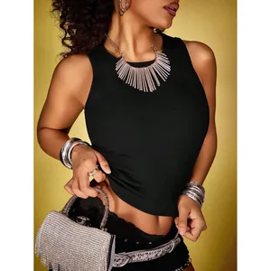 Black ribbed fixed cup camisole tank top styled with silver fringe statement necklace