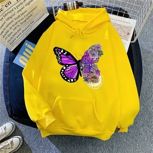 Close-up detail of butterfly and flower graphic print on yellow oversized hoodie