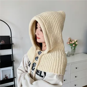 Side view of cream knitted hooded scarf with decorative black buttons for women