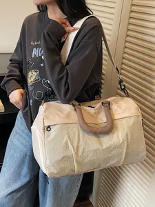 Stylish beige travel duffle bag with shoulder strap for short trips and outdoor sports