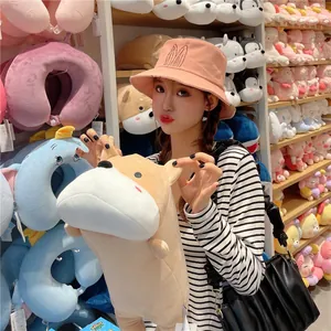 Cute pink bucket hat for women featuring embroidered rabbit ears in a lifestyle toy store