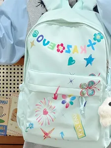 Fashionable mint green backpack for women featuring colorful doodle prints for spring season