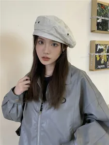 Stylish Asian woman wearing a retro off-white washed denim beret for autumn fashion