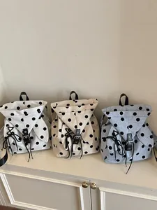 Set of three casual polka dot backpacks in white, beige and blue linen canvas fabrics