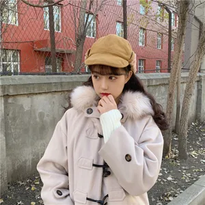 Lifestyle view of an Asian model wearing a cozy yellow plush winter trapper hat