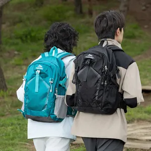 Two hikers wearing teal and black outdoor backpacks while walking in a forest park