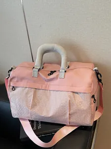 Fashionable pink travel duffel bag with grid pattern for short trips and commuting