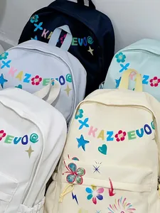 Set of colorful fashion backpacks with artistic letter prints and doodle patterns for women.