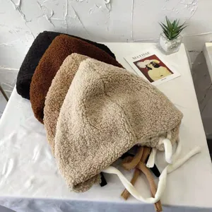 Collection of multi-colored plush sherpa earflap hats for women in cozy neutral winter tones.