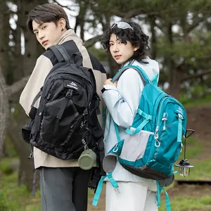 Outdoor lifestyle shot showcasing waterproof hiking backpacks in black and teal