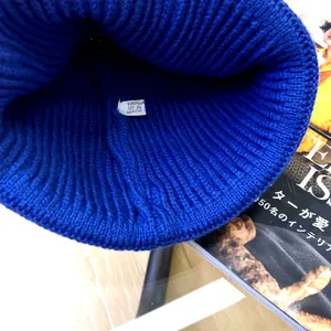 Close-up of the inner blue knitted fabric and washing label for children's beanie hat.