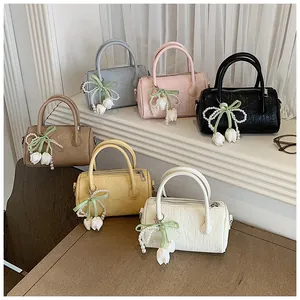 Small pillow bags in various pastel colors featuring elegant tulip pearl bow charms