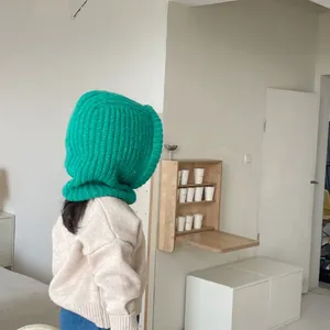 Cozy green knitted balaclava hood with integrated neck warmer for winter protection