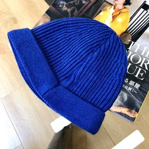 Close-up of vibrant royal blue ribbed knitted beanie for children with rolled edge
