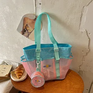 Large pink and turquoise mesh tote bag with multiple pockets and matching coin pouch