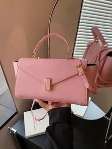 Elegant pink top-handle handbag with gold clasp and adjustable strap for women