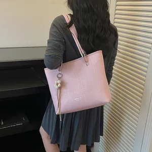Stylish pink large capacity tote bag for women shown on model for daily commuting
