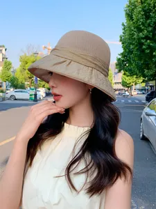 Elegant beige sun hat for women featuring a stylish pleated brim design for summer outings