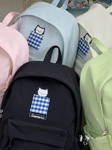 Collection of vibrant Japanese style schoolbags with cat embroidery and plaid details