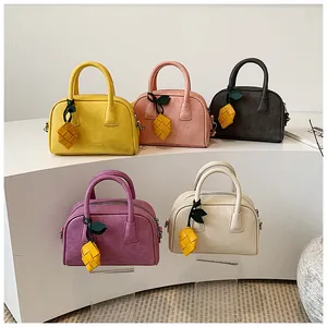 Exquisite variety of colorful suede-style pillow bags with cute pineapple charms.