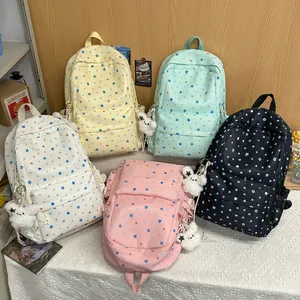 Selection of colorful star pattern student backpacks with cute plush charms