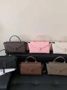 Fashionable multi-color trapezoid leather handbags featuring elegant gold V-clasp details