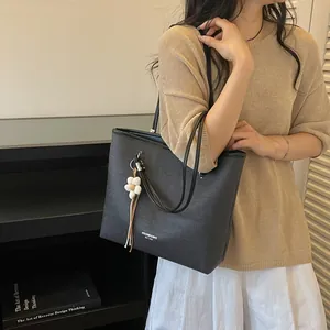 Chic black large capacity tote bag shown on a model for an elegant commute style