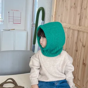 Side view of child wearing a vibrant green knitted balaclava hood for cozy winter warmth