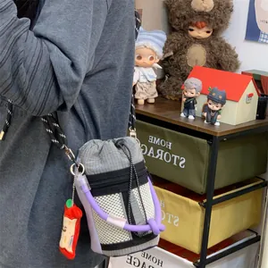 Detailed shot of a niche crossbody bucket bag with mesh pocket and cute apple charm