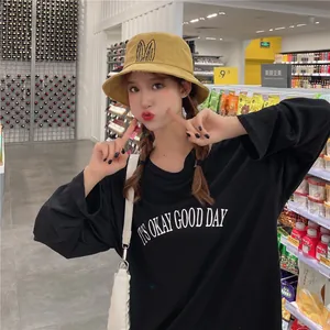 Young woman wearing a cute yellow bucket hat with bunny ears in a store setting