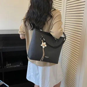 Elegant black large capacity tote bag for women's commuting with stylish flower charm detail