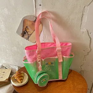 Large mesh tote bag with pink and green color-block design and coin purse charm