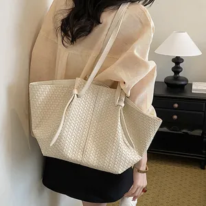 Creamy white woven leather tote bag with elegant texture for casual spring outfits