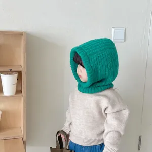 Close-up detail of the vibrant green knitted child balaclava hood for winter warmth