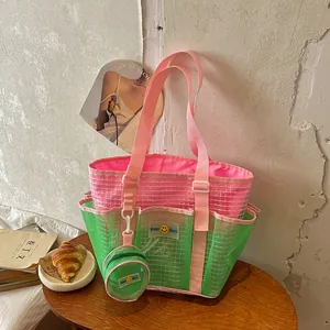 Detail view of a vibrant pink and green mesh tote bag with a matching small round pouch.