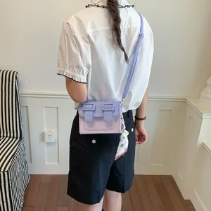 Stylish small purple color-clash square crossbody bag shown on an Asian model back view.