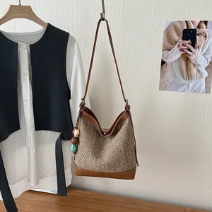Summer large capacity women's woven shoulder bucket bag in a lifestyle setting
