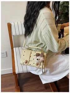 Elegant retro polka dot small square crossbody bag featuring a cute plush bear pendant