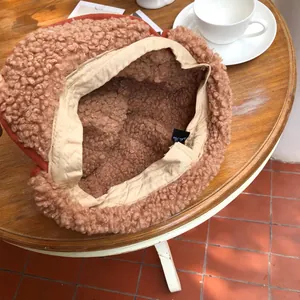 Detailed view of plush trapper hat with warm thick fleece lining and beige interior