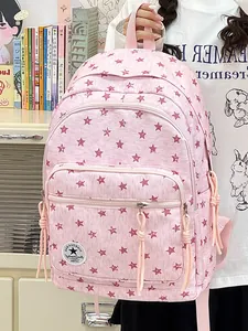 Detail of pink student backpack with red star pattern and multiple zip compartments