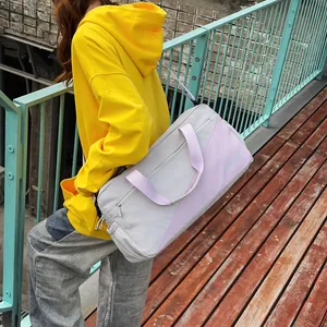 Outdoor view of a model carrying a stylish grey and purple leisure tote bag on a walkway