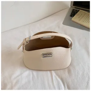 Interior detail view of a cream lychee pattern bucket bag showing its spacious compartment