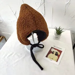 Warm brown sherpa earflap hat with black bow tie, winter hood for women detail view